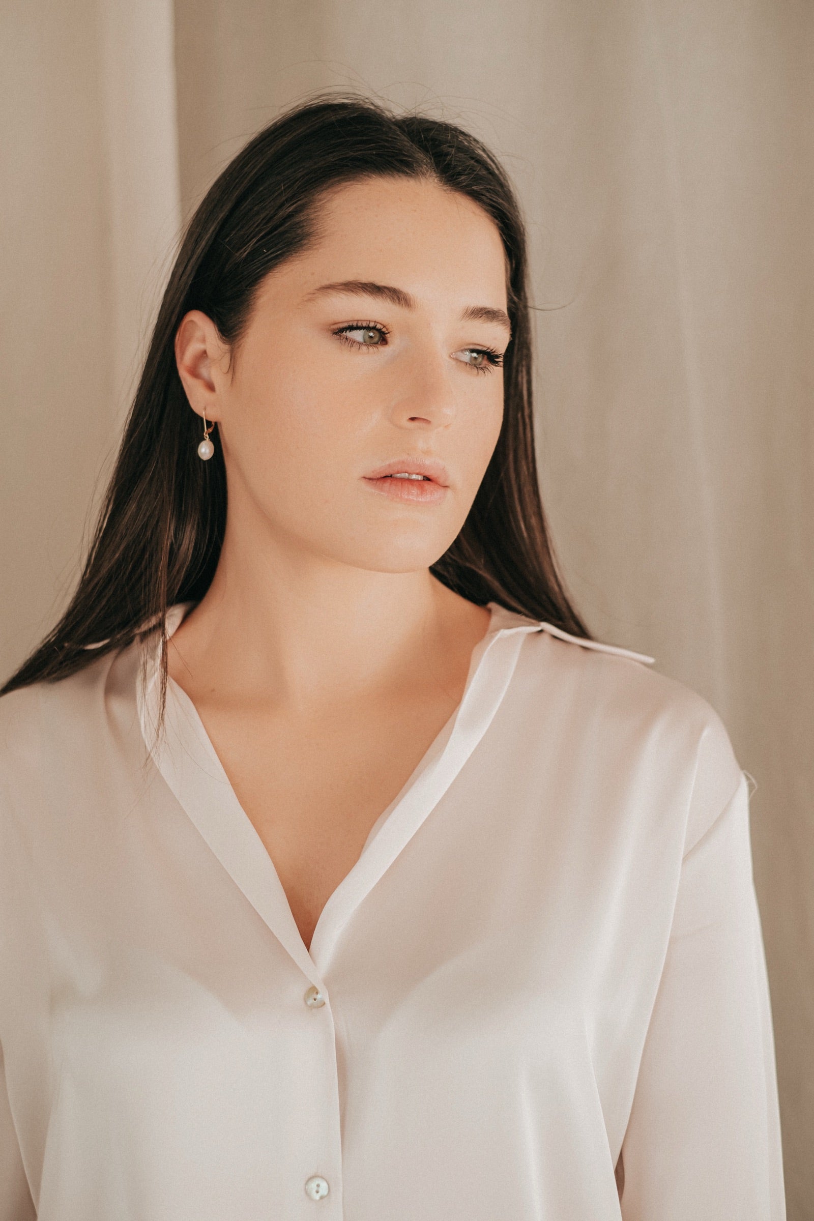Model wearing pearl drop earring